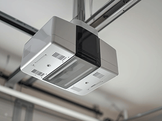 Ceiling-mounted smart garage door opener with sleek design, highlighting advanced features for quiet, reliable, and secure operation.