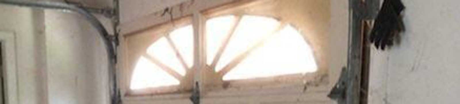 Inside view of broken garage door with bent panels needing replacement in La Canada Flintridge, CA