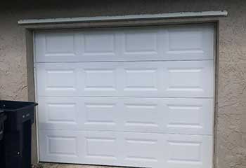Newly painted white garage door after professional service at Pasadena home