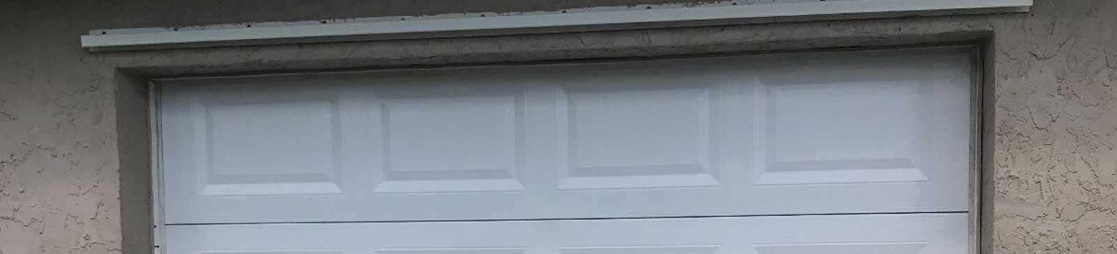 Newly painted white garage door after professional service at Pasadena home