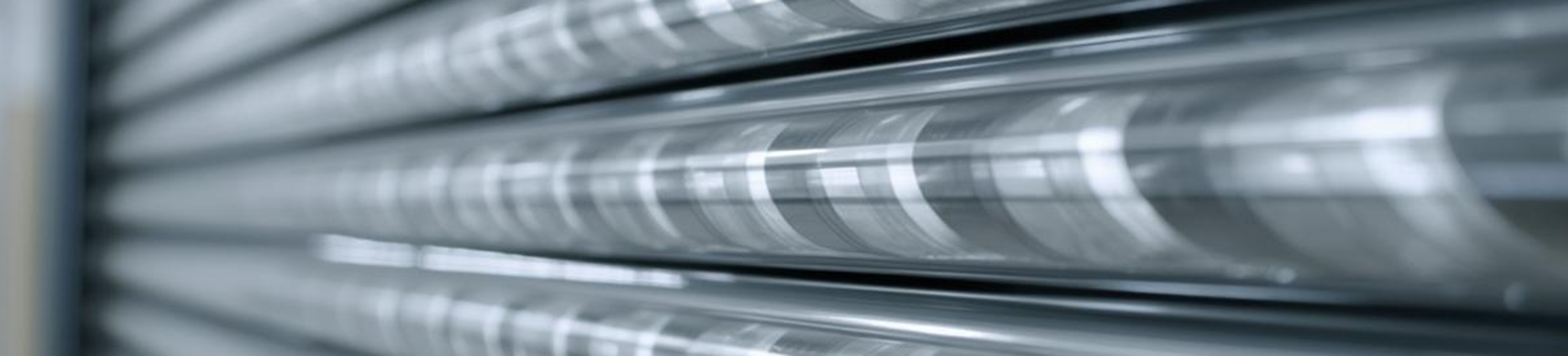 Detailed close-up of coiled steel torsion springs mounted on a garage door shaft, illustrating essential garage door mechanics.