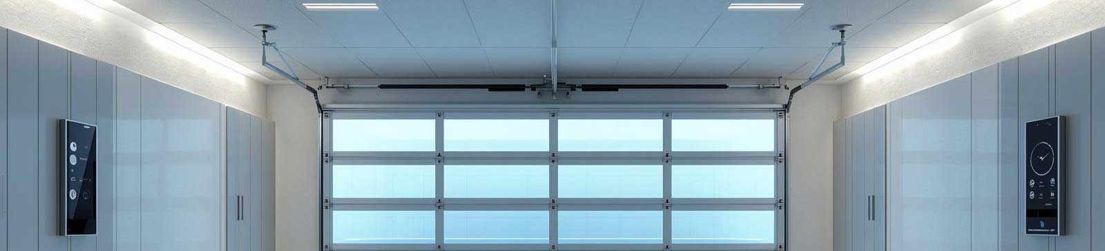 Bright, modern garage with a smart glass-panel garage door, ceiling-mounted Wi-Fi opener, and integrated control panels, illustrating the latest in garage door technology.